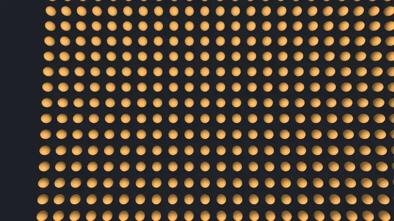Orange spheres in regular rows, seen from straight above and close, larger than in the overview, covering most of the frame, with an empty dark strip along the left edge beyond the grid’s corner.